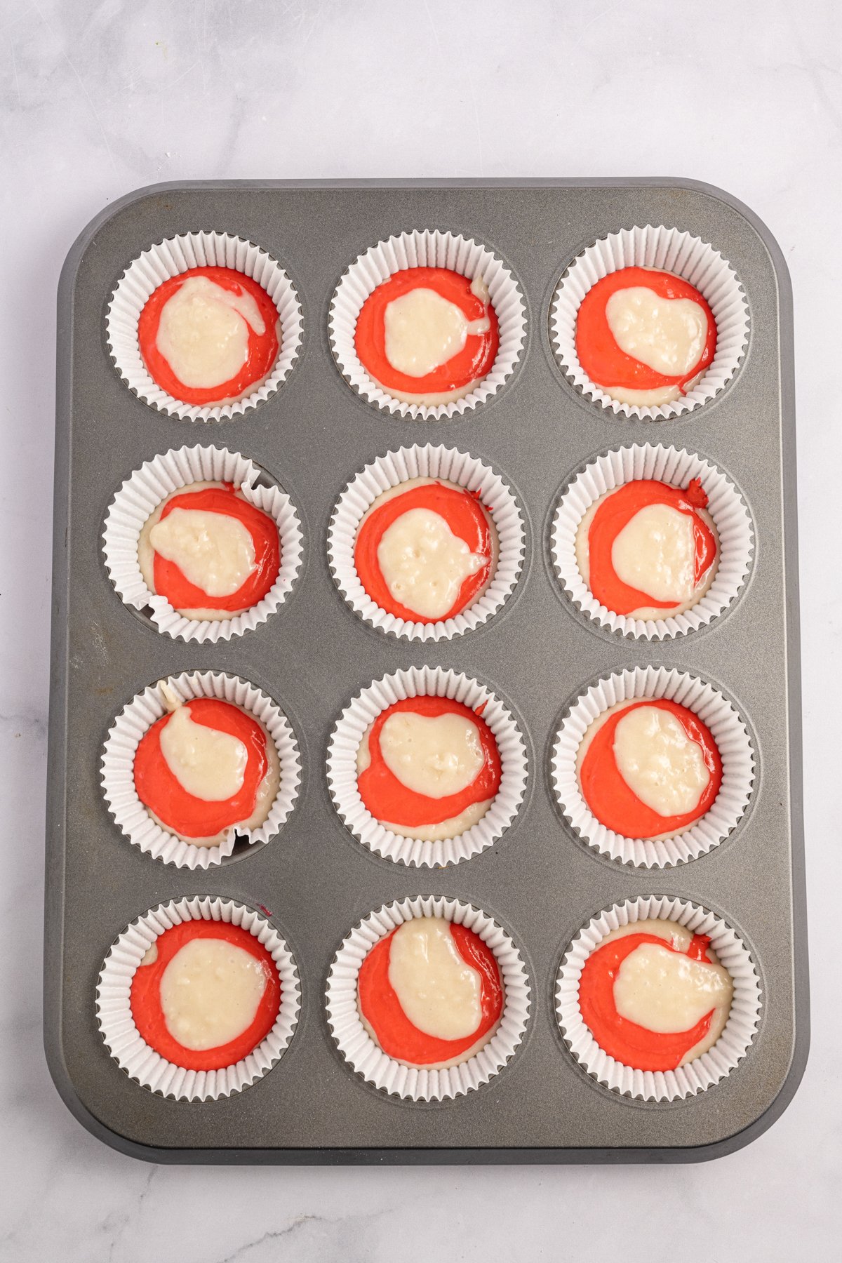 candy cane cupcake batter in muffin tins