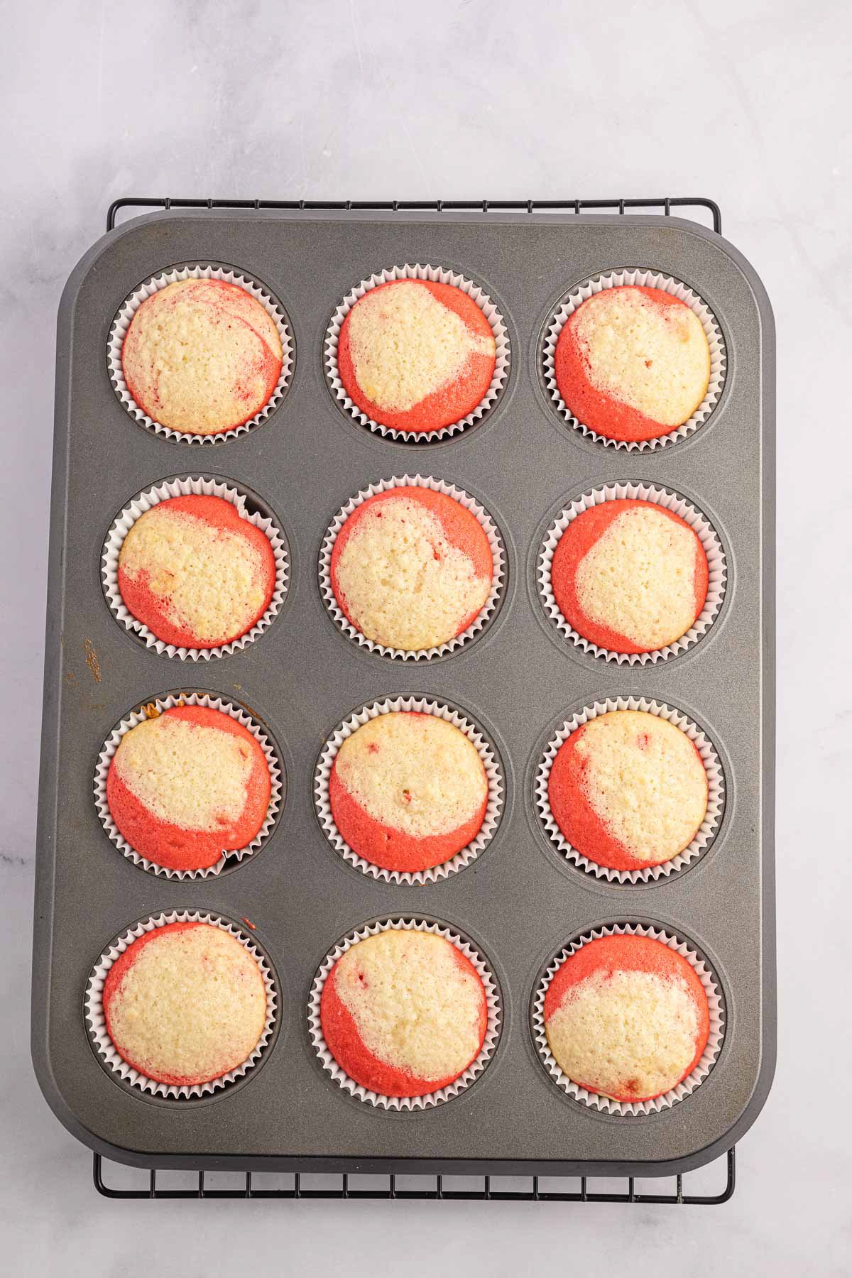 unfrosted candy cane cupcakes in a muffin tin