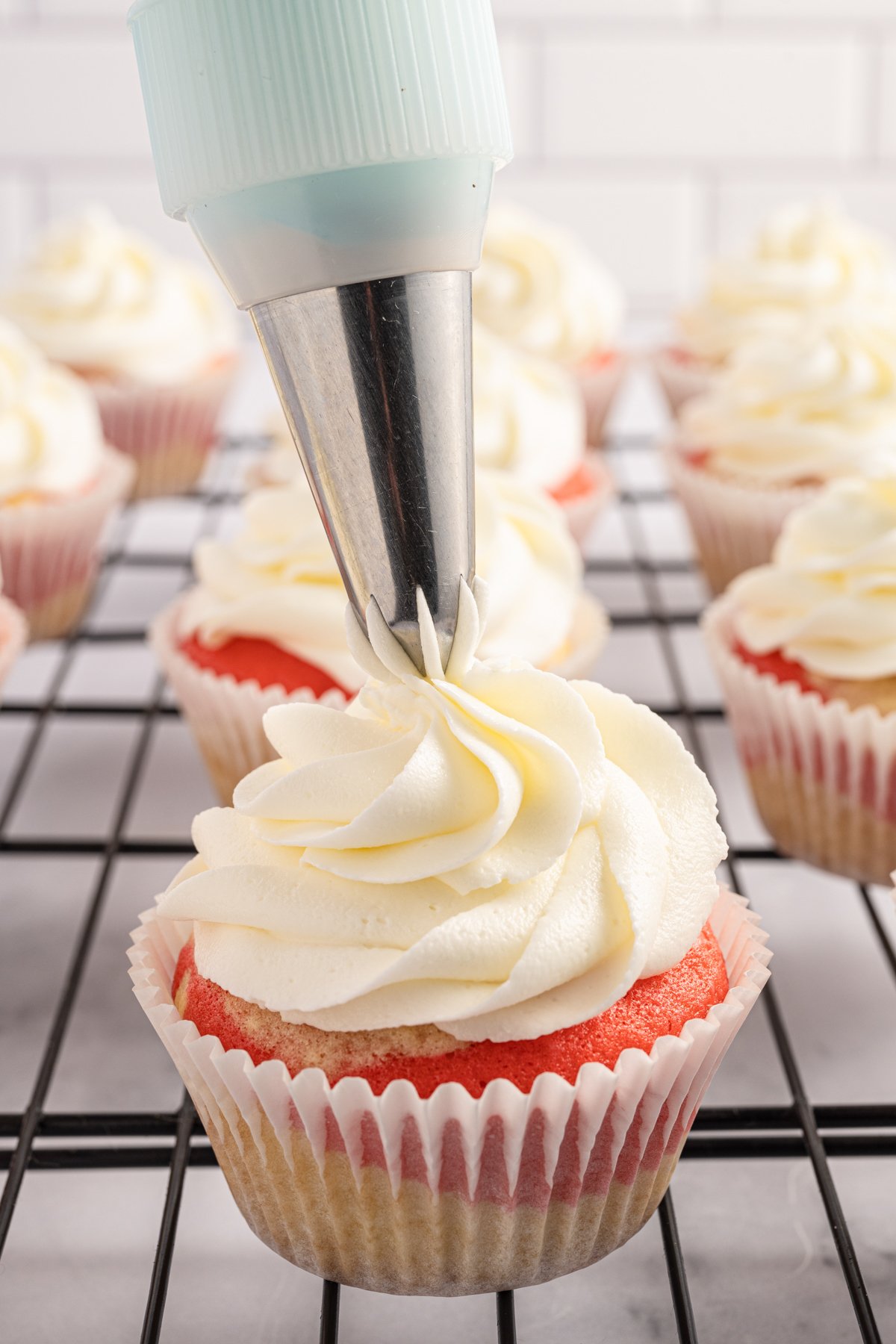 piping bag decorating candy cane cupcakes