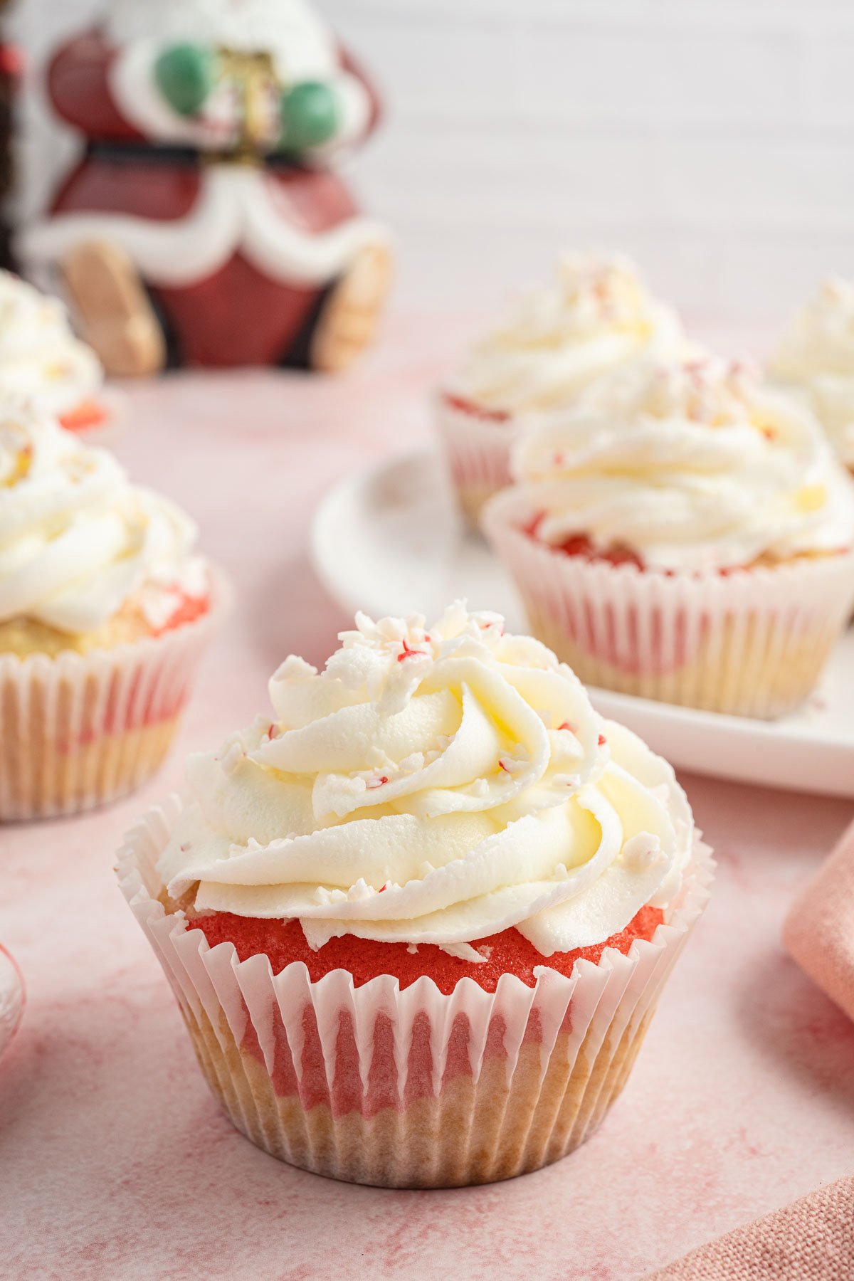 candy cane cupcakes with crushed peppermint on top