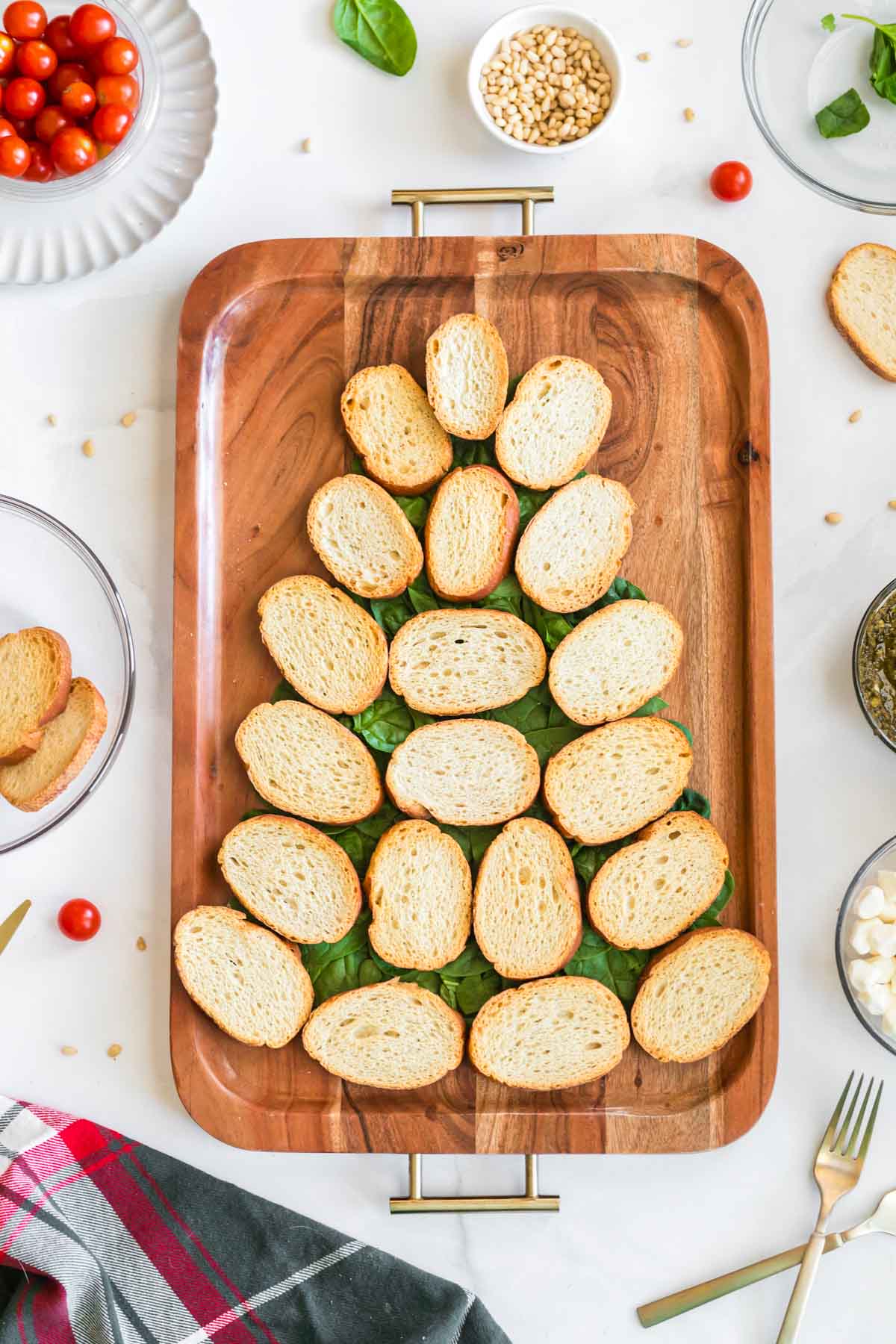 pieces of french bread in the shape of a Christmas tree on a wood board