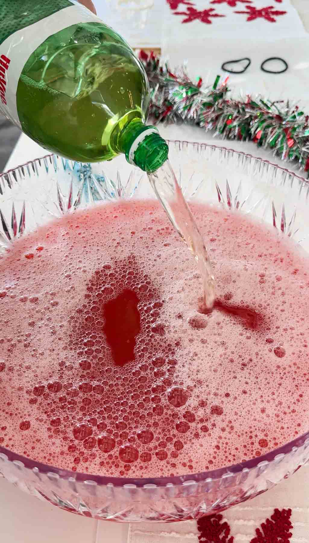 pouring ginger ale into a Santa Claus Christmas punch 