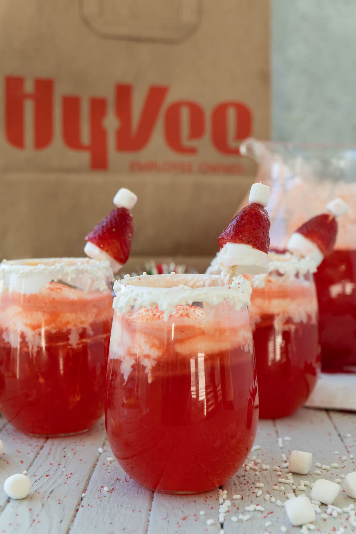 Red Santa Claus Christmas punch with a Hy-Vee bag in the back