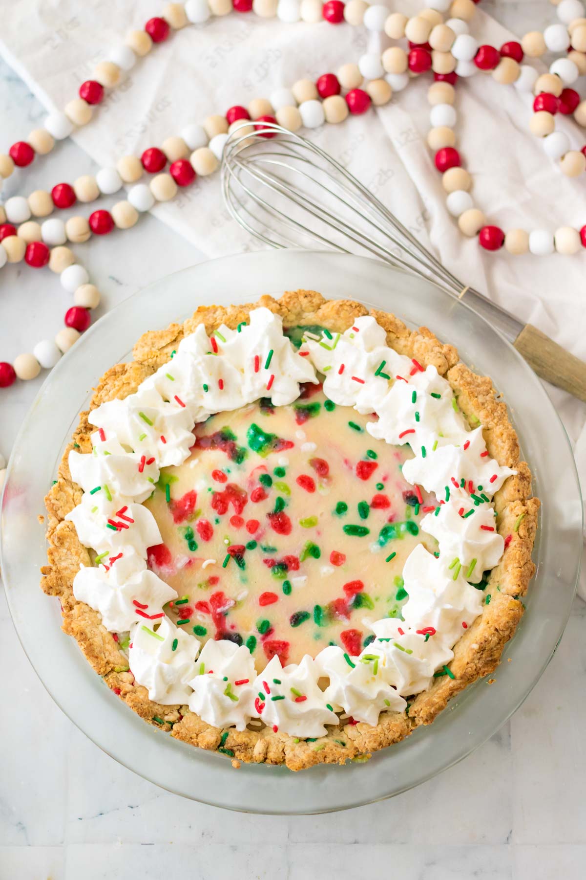 sugar cream pie with whipped cream and sprinkles on top