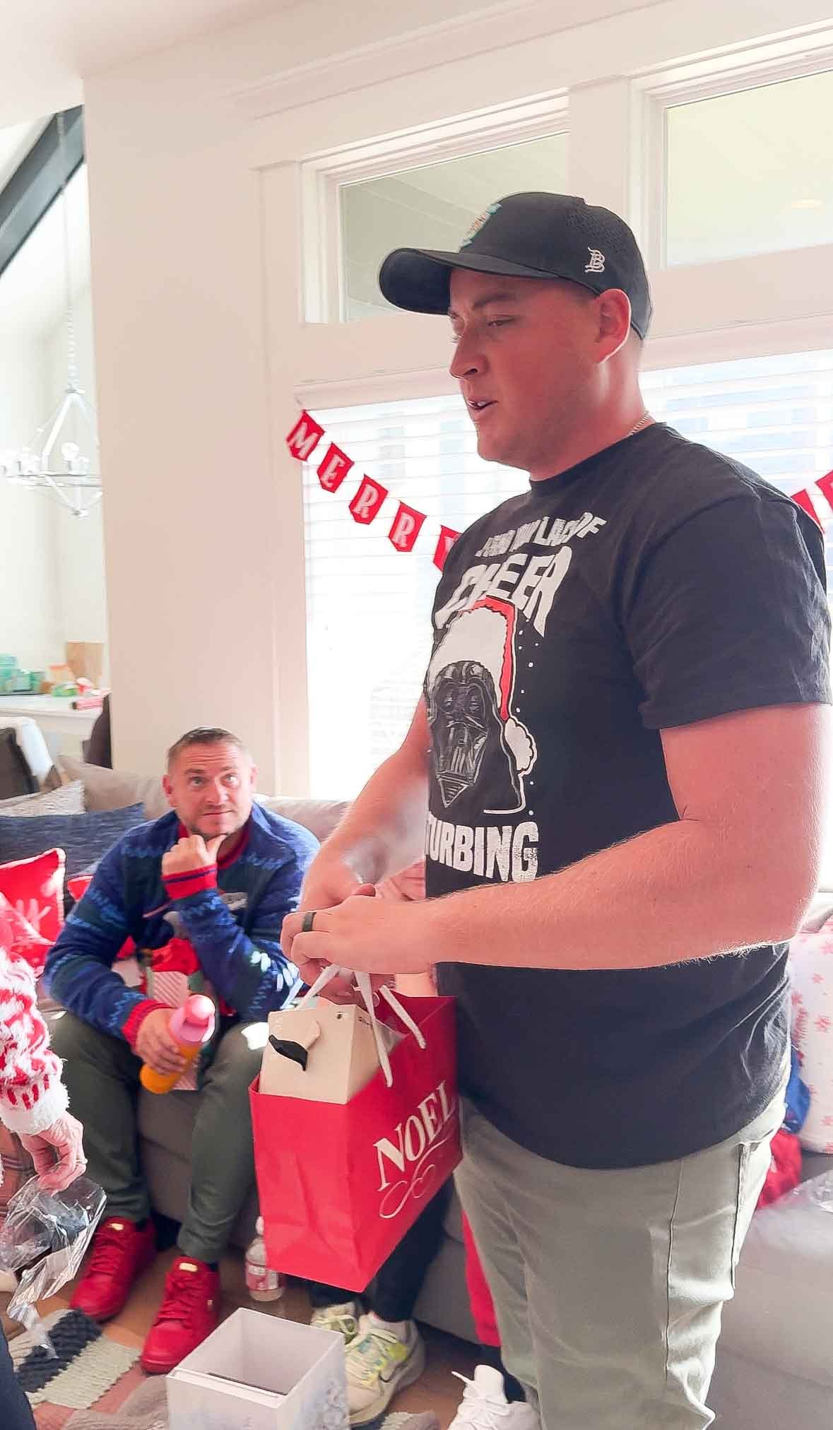 man holding a Christmas gift bag 