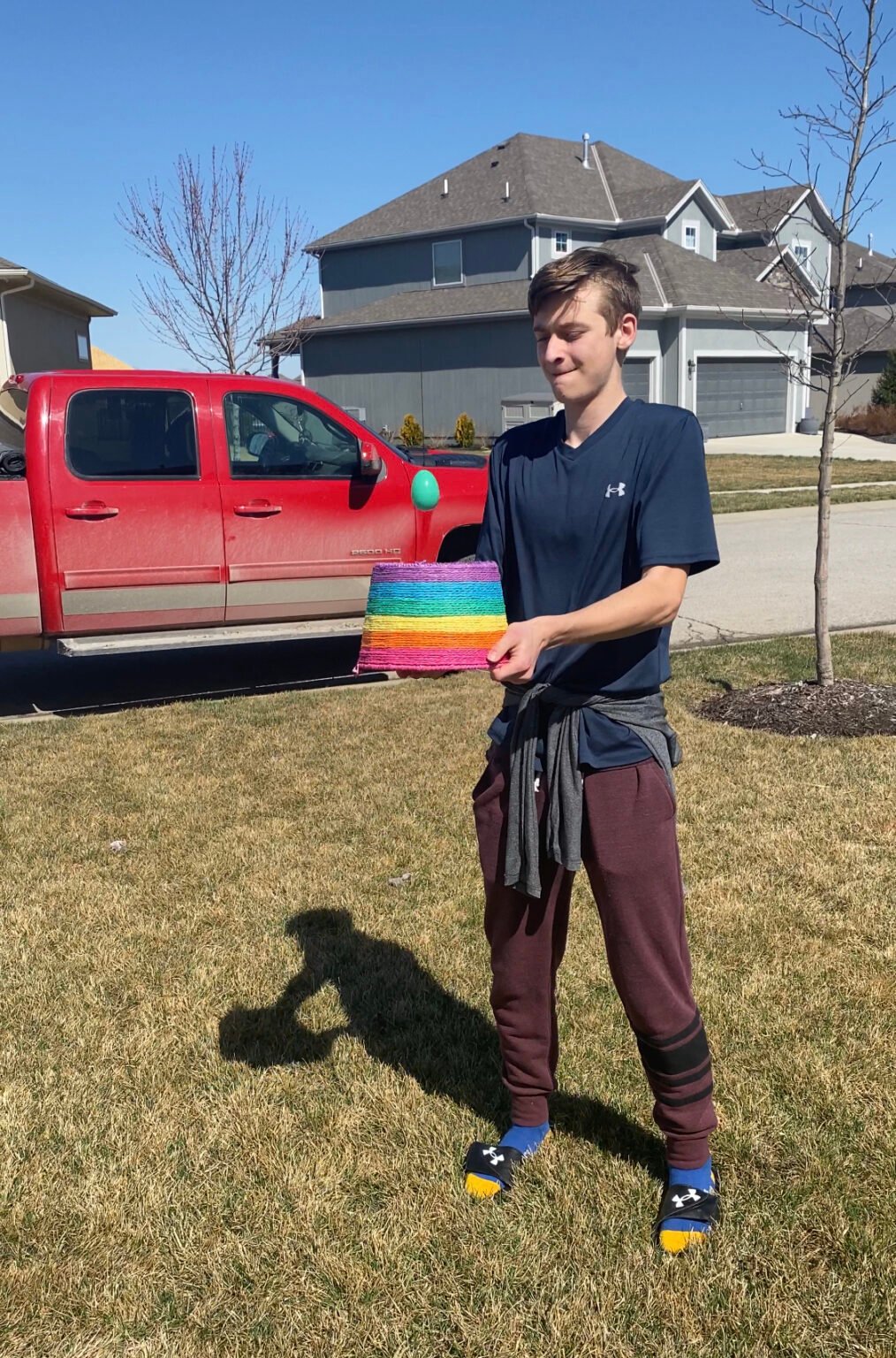 teen boy holding an easter basket with an easter egg