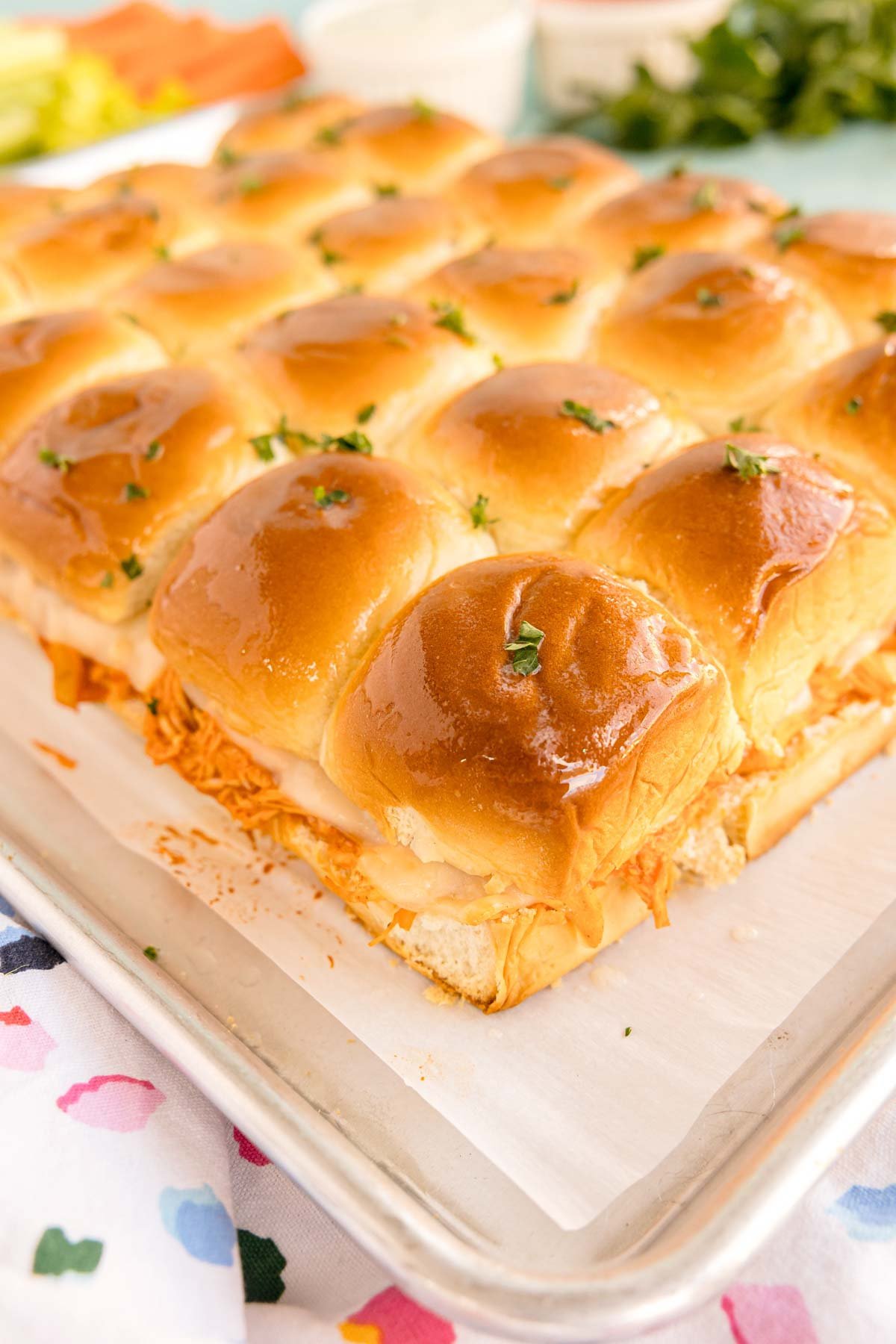 baked buffalo chicken sliders on a baking sheet