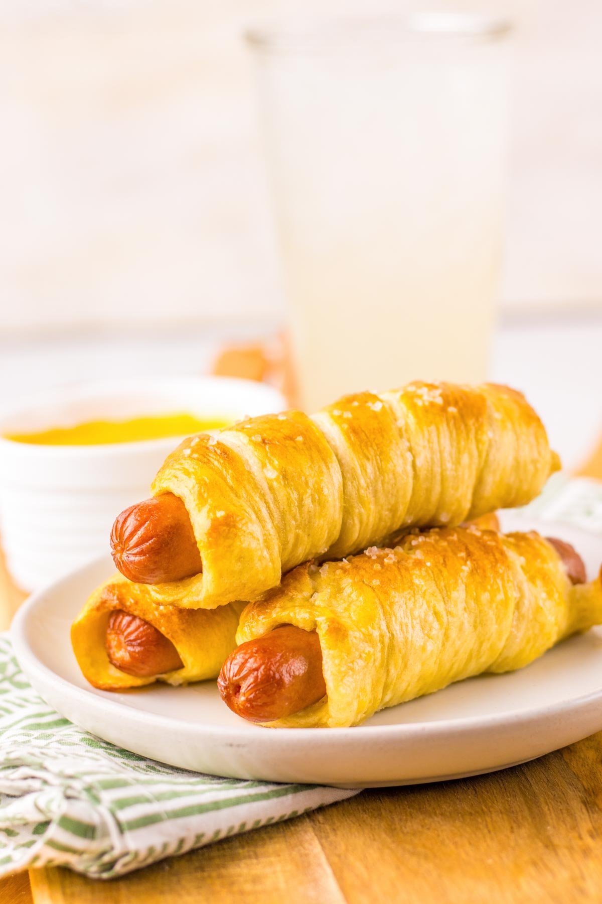 three homemade pretzel dogs stacked on top of each other