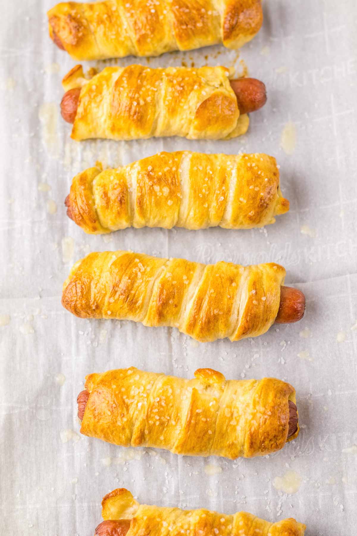 pretzel dogs on a baking sheet