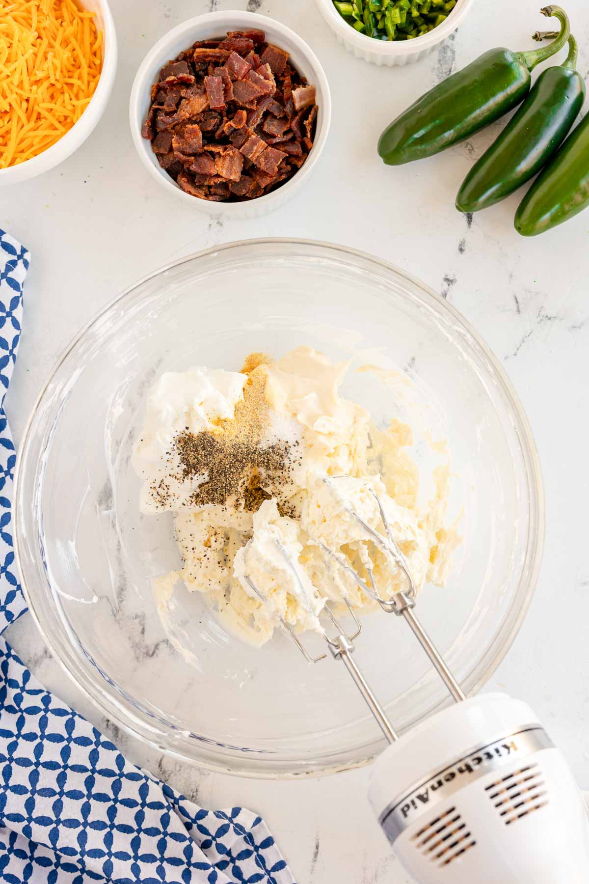 bowl with cream cheese with and salt and pepper