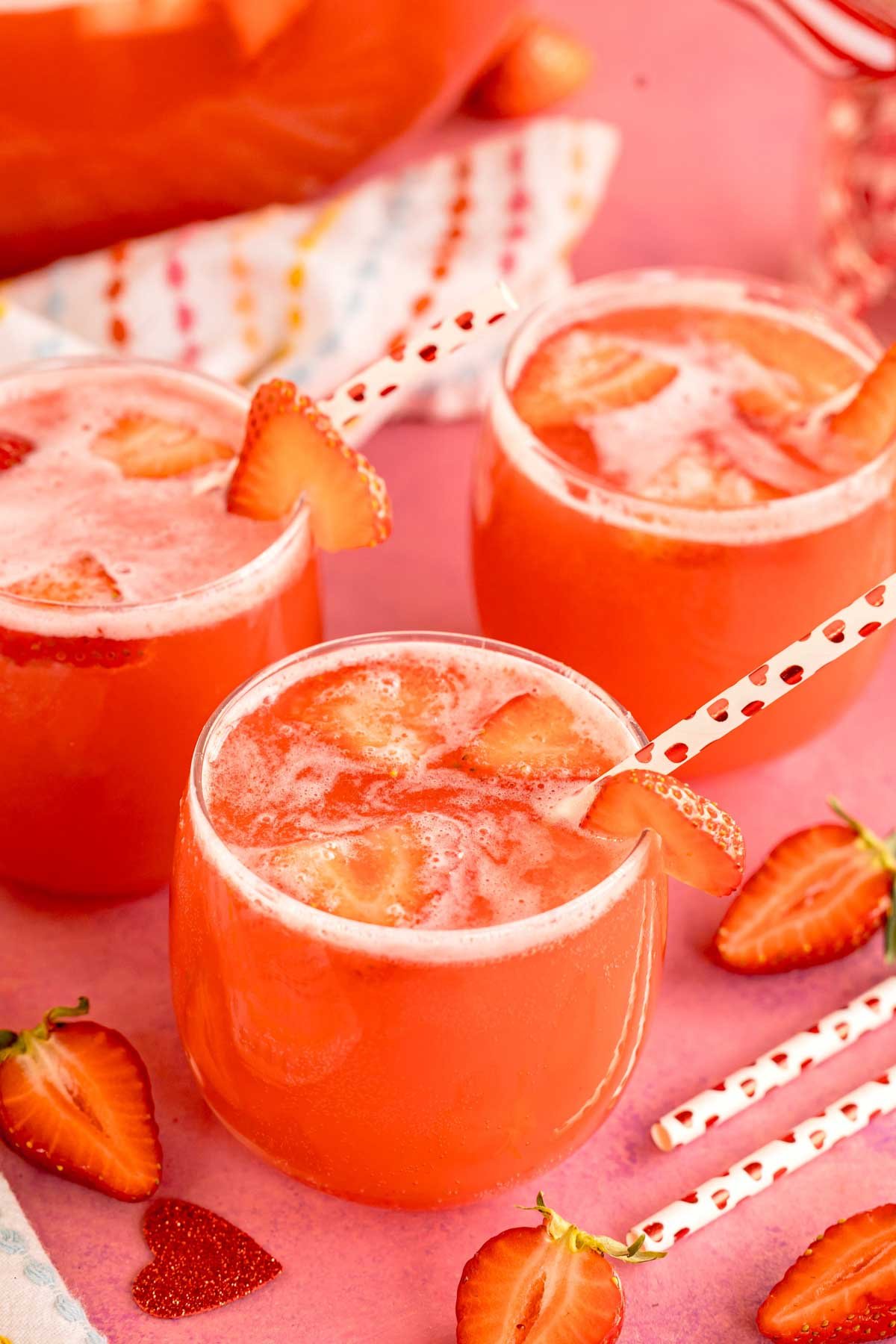 glasses of strawberry punch with straws