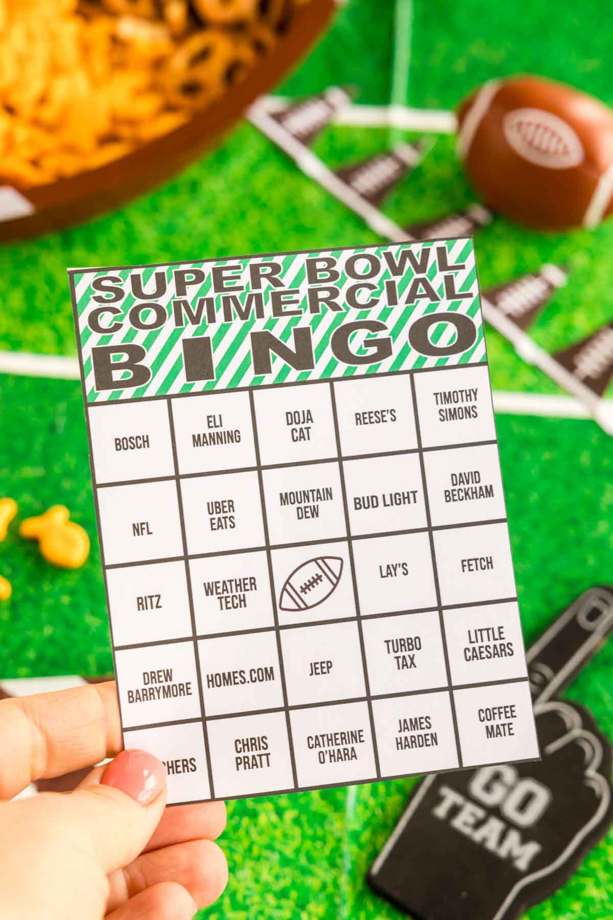 hand holding a Super Bowl commercial bingo card