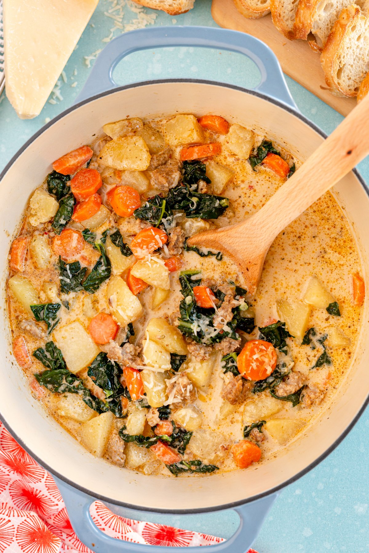 wooden spoon in a pot full of copycat zuppa toscana soup