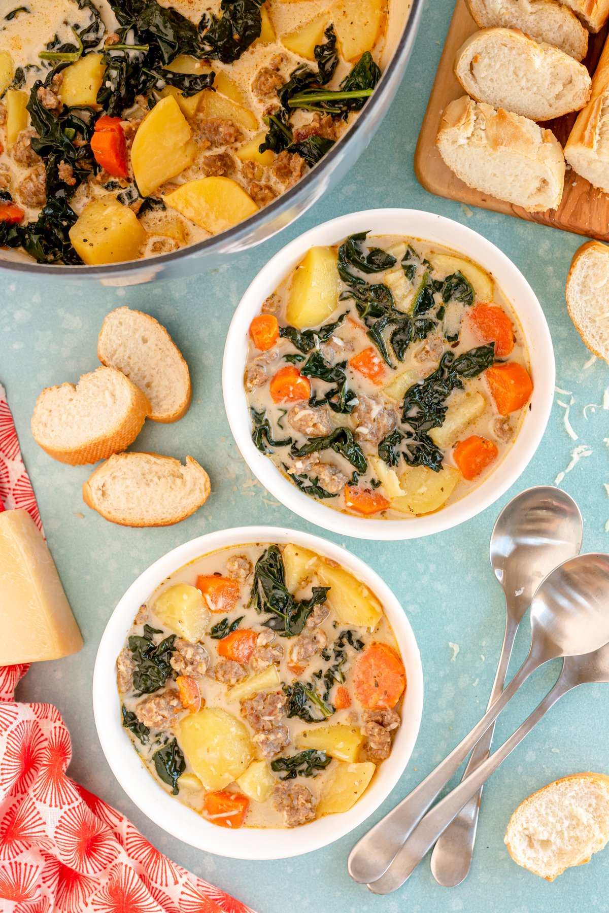 two bowls of Whole 30 zuppa toscana with a pot of it in the corner