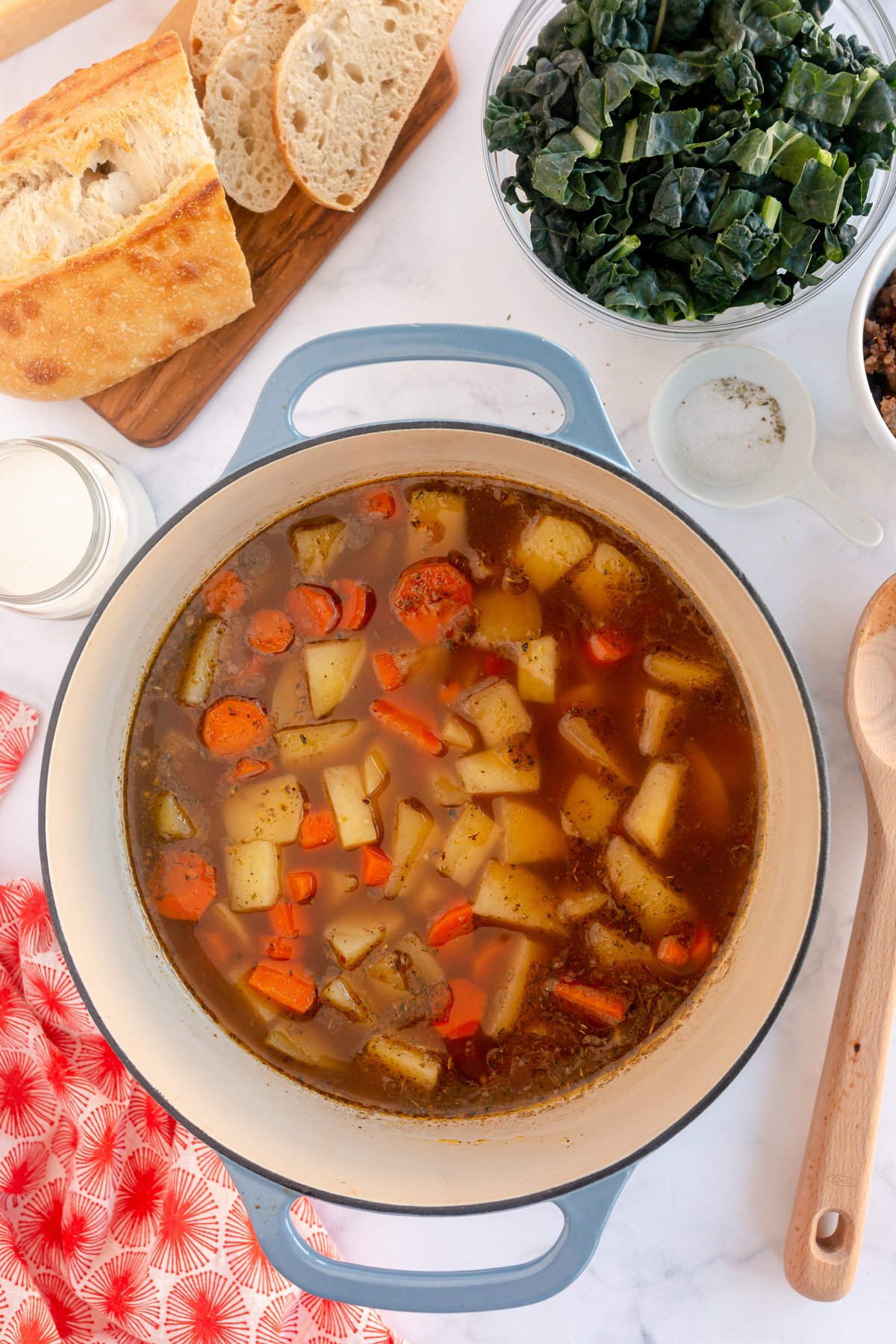 chicken broth, potatoes, and carrots in a big pot