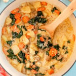 wooden spoon in a pot full of copycat zuppa toscana soup