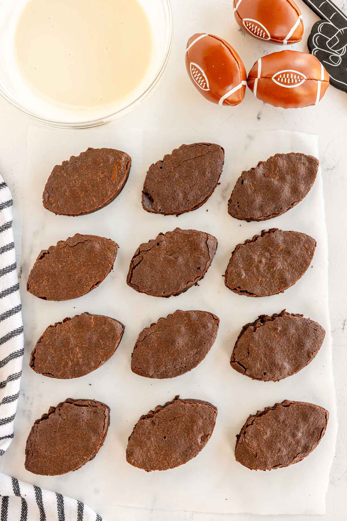 football shaped brownies on a piece of parchment paper