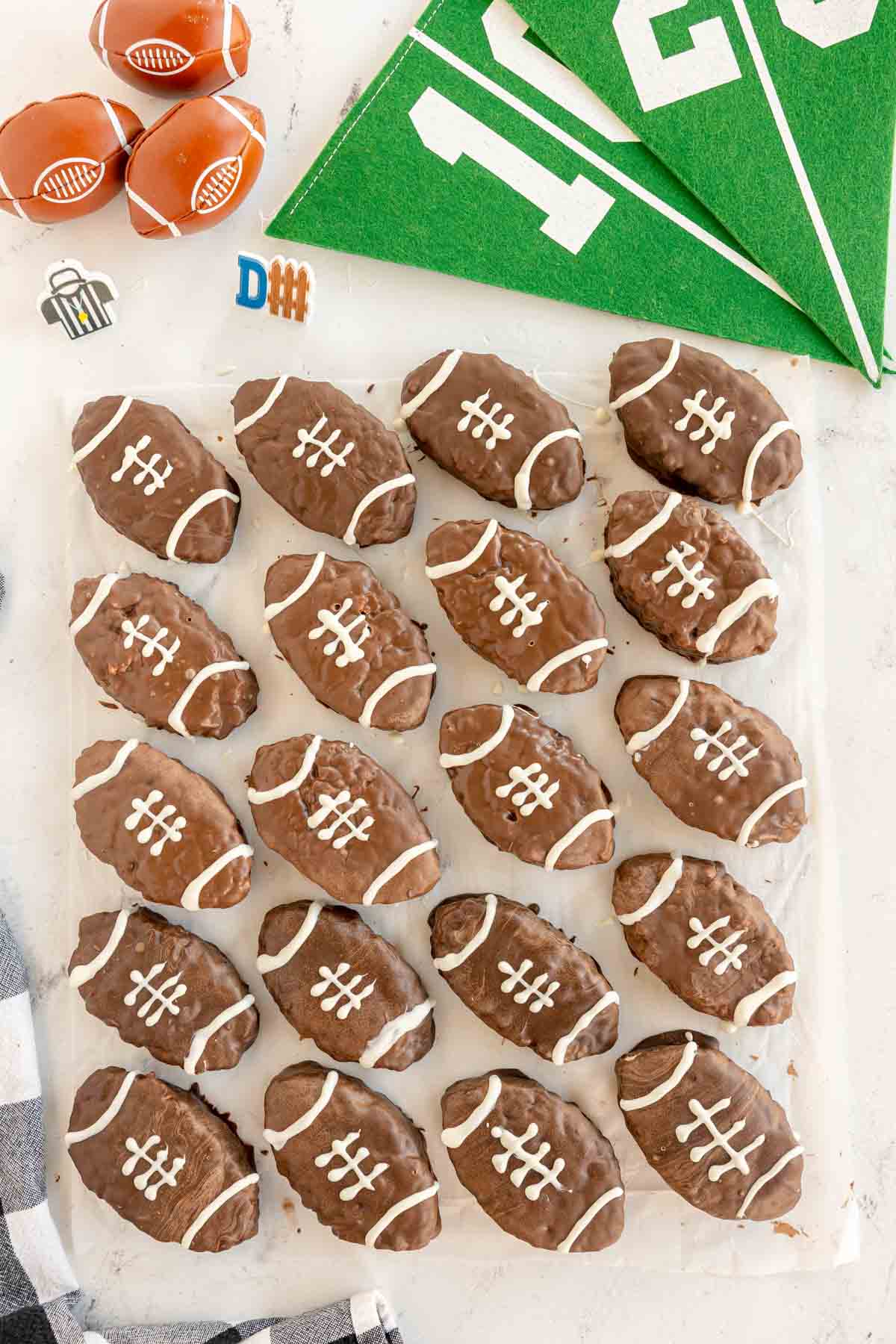 football rice krispy treats on a piece of parchment paper