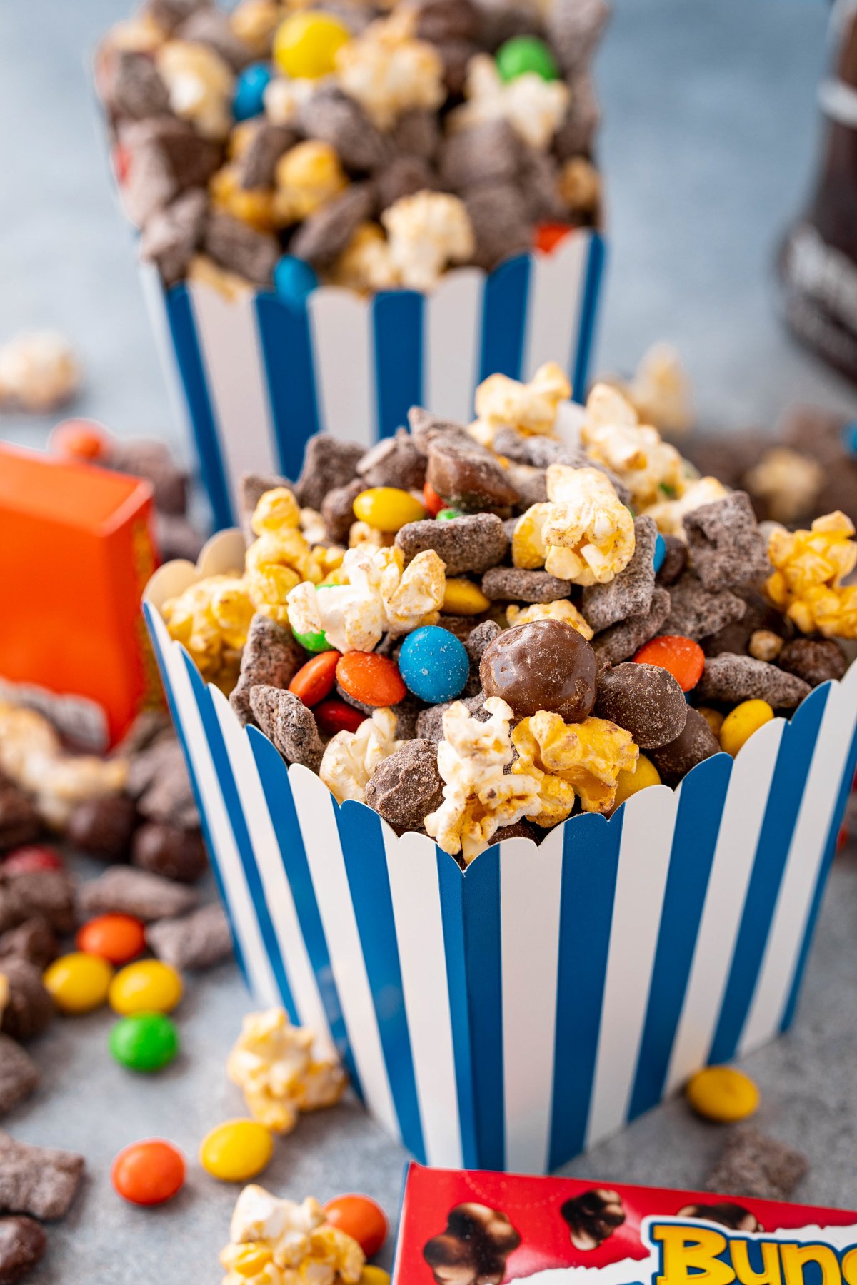 popcorn snack mix in a blue popcorn bucket